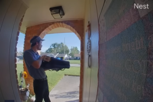 Pizza delivery man standing at door